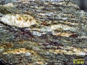 Gneiss du Velay. Orthogneiss provenant du métamorphisme de granites monzonitiques porphyroïdes (528 Ma, Cambrien supérieur). Ils constituent le toit du granite du Velay. Ce sont des gneiss oeillés, foliés à porphyroclastes de feldspath potassique, quartz, biotite, plagioclases, feldspath potassique, sillimanite. Les porphyroclastes sont des phénocristaux magmatiques hérités du granite. De la muscovite tardive apparaît sur les feldspaths potassiques. <a href='http://svt.enseigne.ac-lyon.fr/spip/spip.php?article153' target='_blank'>Page liée</a>.<br />  Mots clefs: gneiss oeillés - métamorphisme - felspath.
 [24826 views]