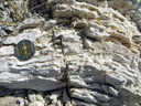 Gypse saccharoïde du Trias supérieur des Alpes. Le gypse est du sulfate de calcium hydraté, de formule chimique CaSO<sub>4</sub>, 2(H<sub>2</sub>O). Il est ici cristallisé sous forme de petits grains grossiers qui le font ressembler à du sucre en morceau, d'où son nom. C'est une roche sédimentaire évaporitique : il se forme par précipitation au niveau de lagunes ou de lacs salés, suite à une forte évaporation et à une concentration des eaux en sels.  Le chauffage artificiel du gypse provoque une réaction de déshydratation partielle : la poudre obtenue est le plâtre, qui recristallisera si on lui ajoute de l'eau.
Vue des roches en place : <a href=' https://phototheque.enseigne.ac-lyon.fr/photossql/photos.php?RollID=images&FrameID=gypses_Izoard'>Col de l'Izoard</a>.
 [2141 views]