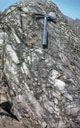 Marbre bréchique d'Ibel, près de Kédougou, Sénégal oriental, d'âge birimien, 2100 Ma. 
Ces marbres se présentent en intercalations dans le supergroupe métasédimentaire épimétamorphique de Dialé-Daléma du Birimien, de la boutonnière de Kédougou-kénieba (Sénégal et Mali). Des éléments de marbre allongés, à terminaisons arrondies ou anguleuses, sont cimentés par de la calcite. Il existe aussi quelques rognons de quartz (en brun clair). Le litage pourrait être originel avec étirement tectonique ou provenir de la resédimentation de clastes (intraclastes). Présentant plusieurs coloris et susceptibles d'un beau poli, ces marbres sont exploités épisodiquement depuis 50 ans dans la carrière d'Ibel et employés pour l'ornementation dans divers bâtiments publics et privés au Sénégal, à Dakar notamment. Actuellement ils subissent la concurrence des marbres importés.
 [5760 views]