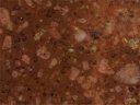 Echantillon de rhyolite du Mâconnais, surface polie scannée. La matrice est colorée en rouge par les oxydes de fer. Les minéraux visibles sont le quartz, le feldspath orthose et d'anciennes biotites transformées en chlorites. [9310 views]