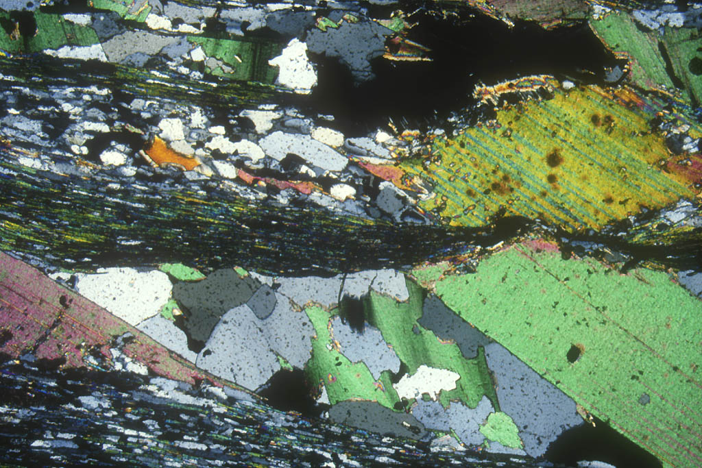 Sur cette photo, on peut observer une schistosité, et des gros minéraux (dont des micas verdâtres) qui se sont formés dans des fentes de tension.